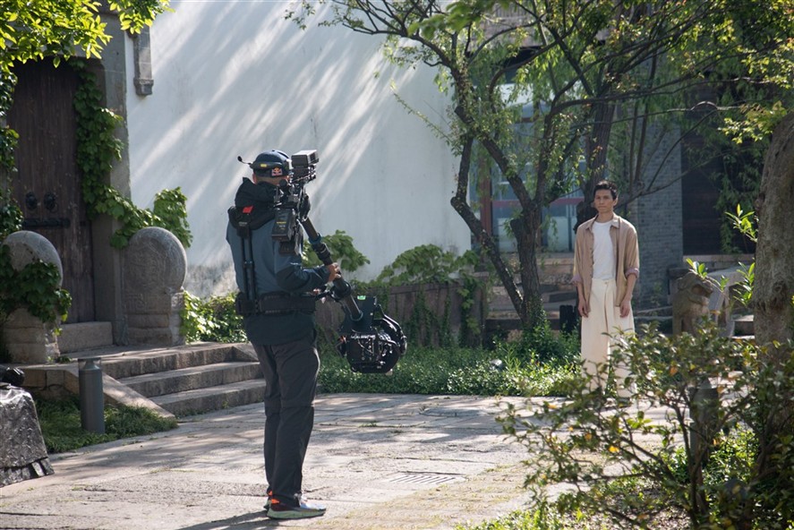 Gimbal operator filming a branded scene outdoors in Shenzhen